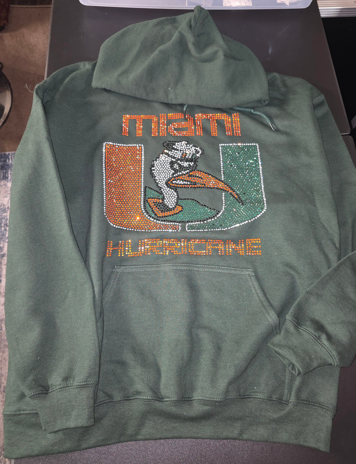 Miami Hurricanes Inspired Rhinestone Hoodie – Forest Green
Show Your Miami Pride in Style! 🧡💚